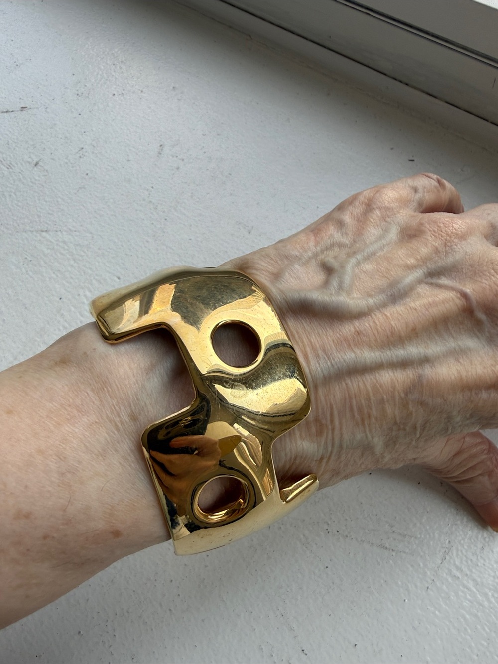 Sculptural Gold Tone Cutout Hinged Cuff Bracelet.
